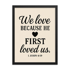 1 John 419 We love because he first loved us framed print on a plain backdrop in size 18"x24".