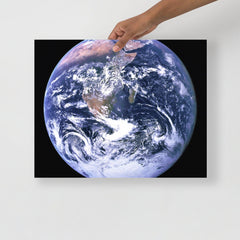 The Blue Marble poster on a plain backdrop in size 16x20”.