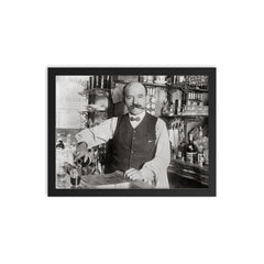 A bartender pouring a drink in 1910, New York City framed print on a plain backdrop in size 12"x16".