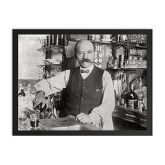 A bartender pouring a drink in 1910, New York City framed print on a plain backdrop in size 18"x24".