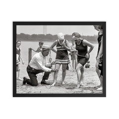 A beach police officer measures the length of a bathing suit to ensure it complies with modesty laws, Washington, DC 1922 framed print on a plain backdrop in size 16"x20".