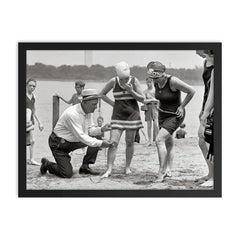 A beach police officer measures the length of a bathing suit to ensure it complies with modesty laws, Washington, DC 1922 framed print on a plain backdrop in size 18"x24".
