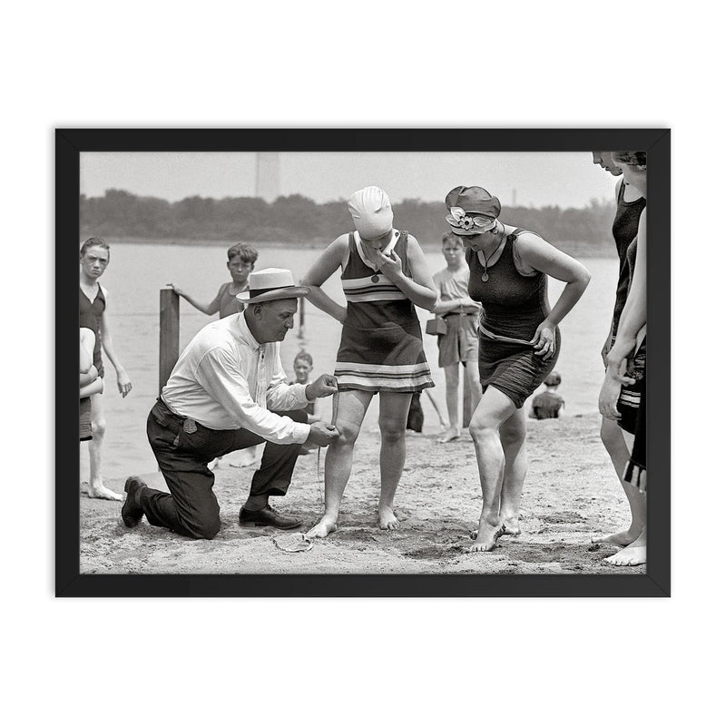 A beach police officer measures the length of a bathing suit to ensure it complies with modesty laws, Washington, DC 1922 framed print on a plain backdrop in size 18