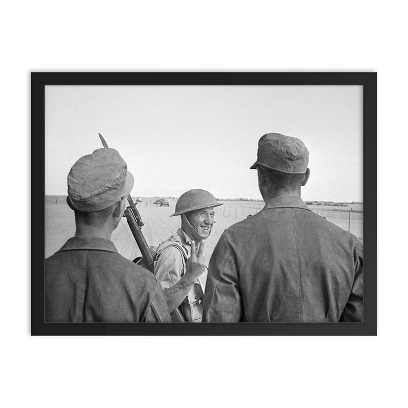 A British Soldier Giving a V-for-Victory Sign to German Prisoners at El Alamein, 26 October 1942 framed print on a plain backdrop in size 18
