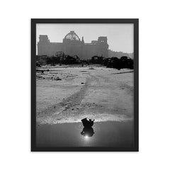 A Broken German Stahlhelm in a Puddle with Reichstag Ruins, Berlin framed print on a plain backdrop in size 16"x20".