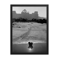 A Broken German Stahlhelm in a Puddle with Reichstag Ruins, Berlin framed print on a plain backdrop in size 18"x24".