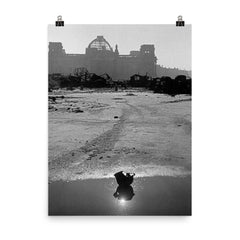 A Broken German Stahlhelm in a Puddle with Reichstag Ruins, Berlin poster on a plain backdrop in size 8"x10".