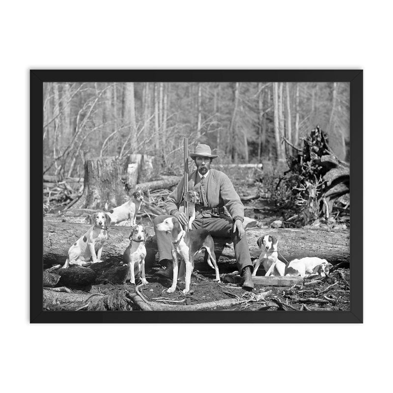 A deer hunter poses for a portrait with his hounds, 1897 framed print on a plain backdrop in size 18