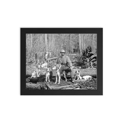 A deer hunter poses for a portrait with his hounds, 1897 framed print on a plain backdrop in size 8"x10".