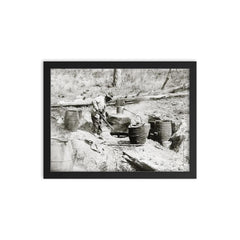 A man operating a moonshine still in a remote location - Texas, 1923 framed print on a plain backdrop in size 12"x16".
