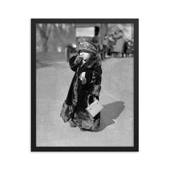 A midget flapper girl wearing the latest flapper fashions and smoking a cigarette, Washington, DC 1924 framed print on a plain backdrop in size 16"x20".