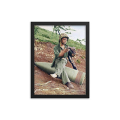 A US Marine Clearing His Boot on a 16” Naval Artillery Shell, Saipan, June 1944 framed print on a plain backdrop in size 12"x16".