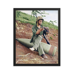 A US Marine Clearing His Boot on a 16” Naval Artillery Shell, Saipan, June 1944 framed print on a plain backdrop in size 16"x20".