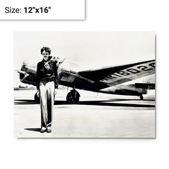 Amelia Earhart standing in front of the Lockheed Electra metal print on a plain backdrop in size 12"x16".