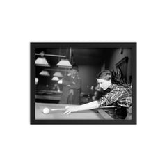 Billiards champ - a female champion billiards player lines up a shot, 1910 framed print on a plain backdrop in size 12"x16".