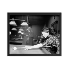 Billiards champ - a female champion billiards player lines up a shot, 1910 framed print on a plain backdrop in size 16"x20".