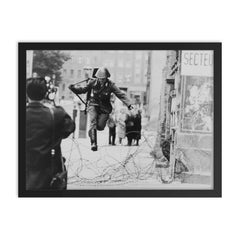 Conrad Schumann Defecting from the German Democratic Republic, August 15, 1961 framed print on a plain backdrop in size 18"x24".