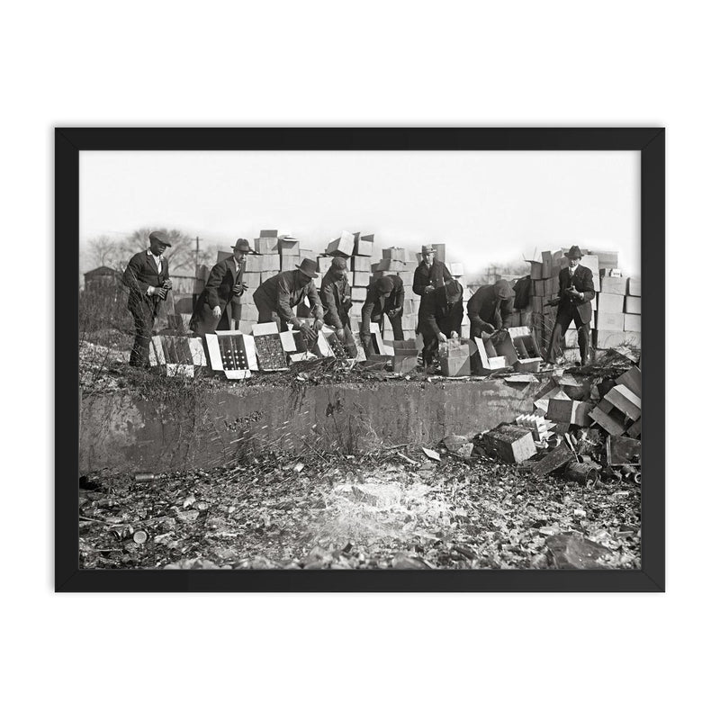 Destroying Bootleg Liquor - Prohibition Agents smashing bottles of seized bootleg whiskey and beer, 1923 framed print on a plain backdrop in size 18