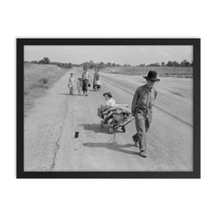 Family walking on highway by Dorothea Lange framed print on a plain backdrop in size 18"x24".
