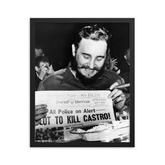 Fidel Castro Laughing at Newspaper Headline, New York 1959 framed print on a plain backdrop in size 16"x20".