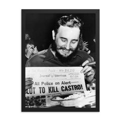 Fidel Castro Laughing at Newspaper Headline, New York 1959 framed print on a plain backdrop in size 18"x24".