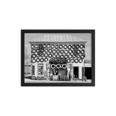Firestone Tire Shop, 1940 - a used tire shop and filling station displaying tires from top to bottom San Marcos, Texas framed print on a plain backdrop in size 12"x16".