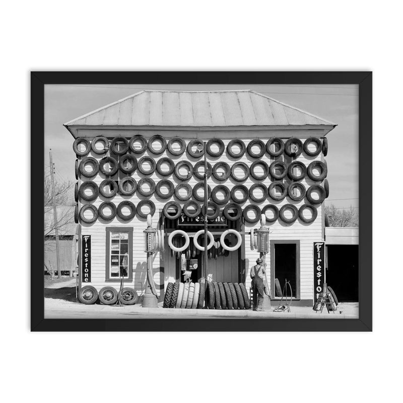Firestone Tire Shop, 1940 - a used tire shop and filling station displaying tires from top to bottom San Marcos, Texas framed print on a plain backdrop in size 18