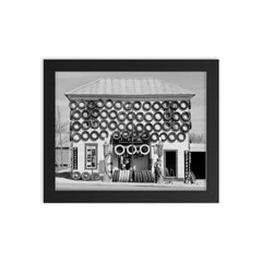 Firestone Tire Shop, 1940 - a used tire shop and filling station displaying tires from top to bottom San Marcos, Texas framed print on a plain backdrop in size 8"x10".
