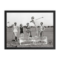 Flapper Girls Playing Golf, 1926 - A flapper girl tees off while standing on a giant block of ice, Washington, DC framed print on a plain backdrop in size 18"x24".