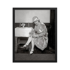 Flask Hidden in Garter, 1926 - A woman reveals a flask hidden in her garter during the Prohibition era framed print on a plain backdrop in size 16"x20".