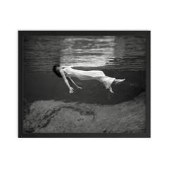 Floating Underwater - A woman floating below the surface of Weeki Wachee Springs, Florida, 1947 framed print on a plain backdrop in size 16"x20".