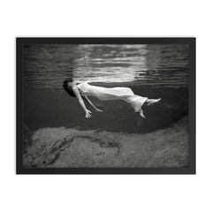 Floating Underwater - A woman floating below the surface of Weeki Wachee Springs, Florida, 1947 framed print on a plain backdrop in size 18"x24".