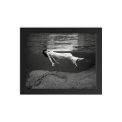 Floating Underwater - A woman floating below the surface of Weeki Wachee Springs, Florida, 1947 framed print on a plain backdrop in size 8"x10".