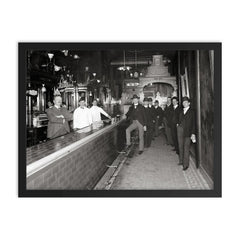 Gentlemen at the bar - a group of gentlemen drinking at a bar pose for a portrait, Dayton, Ohio, 1910 framed print on a plain backdrop in size 18"x24".