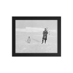 Gilbert Kerr bagpiping with an Emperor Penguin framed print on a plain backdrop in size 8"x10".