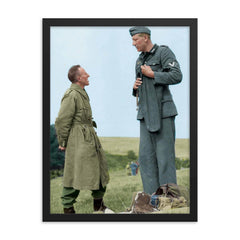 Jakob Nacken (221 cm) Chatting with British Corporal Bob Roberts (160 cm) framed print on a plain backdrop in size 18"x24".