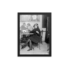 Lady with a hidden flask - a woman pours a drink from a flask hidden inside a cane during the Prohibition era, 1922 framed print on a plain backdrop in size 12"x16".