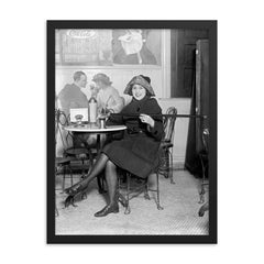 Lady with a hidden flask - a woman pours a drink from a flask hidden inside a cane during the Prohibition era, 1922 framed print on a plain backdrop in size 18"x24".