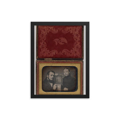 Man and Woman Posing with Family Daguerreotype, c. 1850 framed print on a plain backdrop in size 12"x16".