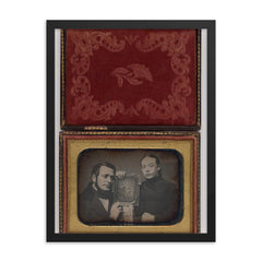 Man and Woman Posing with Family Daguerreotype, c. 1850 framed print on a plain backdrop in size 18"x24".