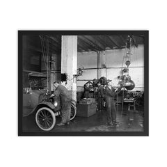 Mechanics at an auto repair shop replacing an engine in an early model car - Washington, DC, 1920 framed print on a plain backdrop in size 16"x20".