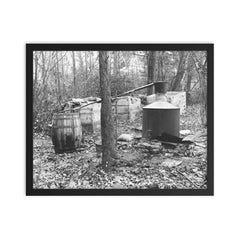 Moonshine still in the woods - A moonshiner's operation discovered by Prohibition Agents in the woods near Rosaryville, Maryland, 1931 framed print on a plain backdrop in size 16"x20".