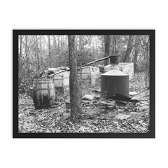 Moonshine still in the woods - A moonshiner's operation discovered by Prohibition Agents in the woods near Rosaryville, Maryland, 1931 framed print on a plain backdrop in size 18"x24".