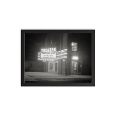 Movie Theater at Night - A movie theater at night with a brightly lit marquee, Greensboro, Georgia, 1940 framed print on a plain backdrop in size 12"x16".