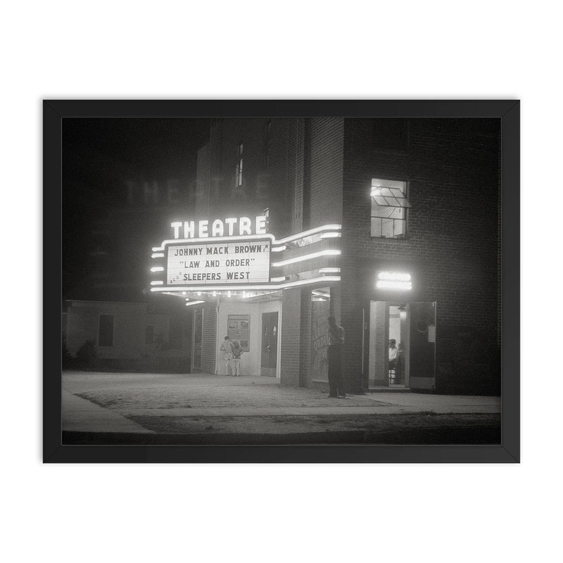 Movie Theater at Night - A movie theater at night with a brightly lit marquee, Greensboro, Georgia, 1940 framed print on a plain backdrop in size 18