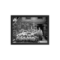 New York City flower shop, 1905 - A florist poses with a display of Easter flowers outside his shop framed print on a plain backdrop in size 12"x16".