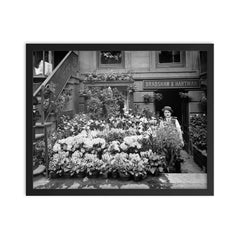 New York City flower shop, 1905 - A florist poses with a display of Easter flowers outside his shop framed print on a plain backdrop in size 16"x20".