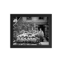 New York City flower shop, 1905 - A florist poses with a display of Easter flowers outside his shop framed print on a plain backdrop in size 8"x10".