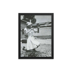 Nurse with an M-3 Grease Gun, WWII 1940s framed print on a plain backdrop in size 12"x16".