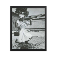 Nurse with an M-3 Grease Gun, WWII 1940s framed print on a plain backdrop in size 16"x20".